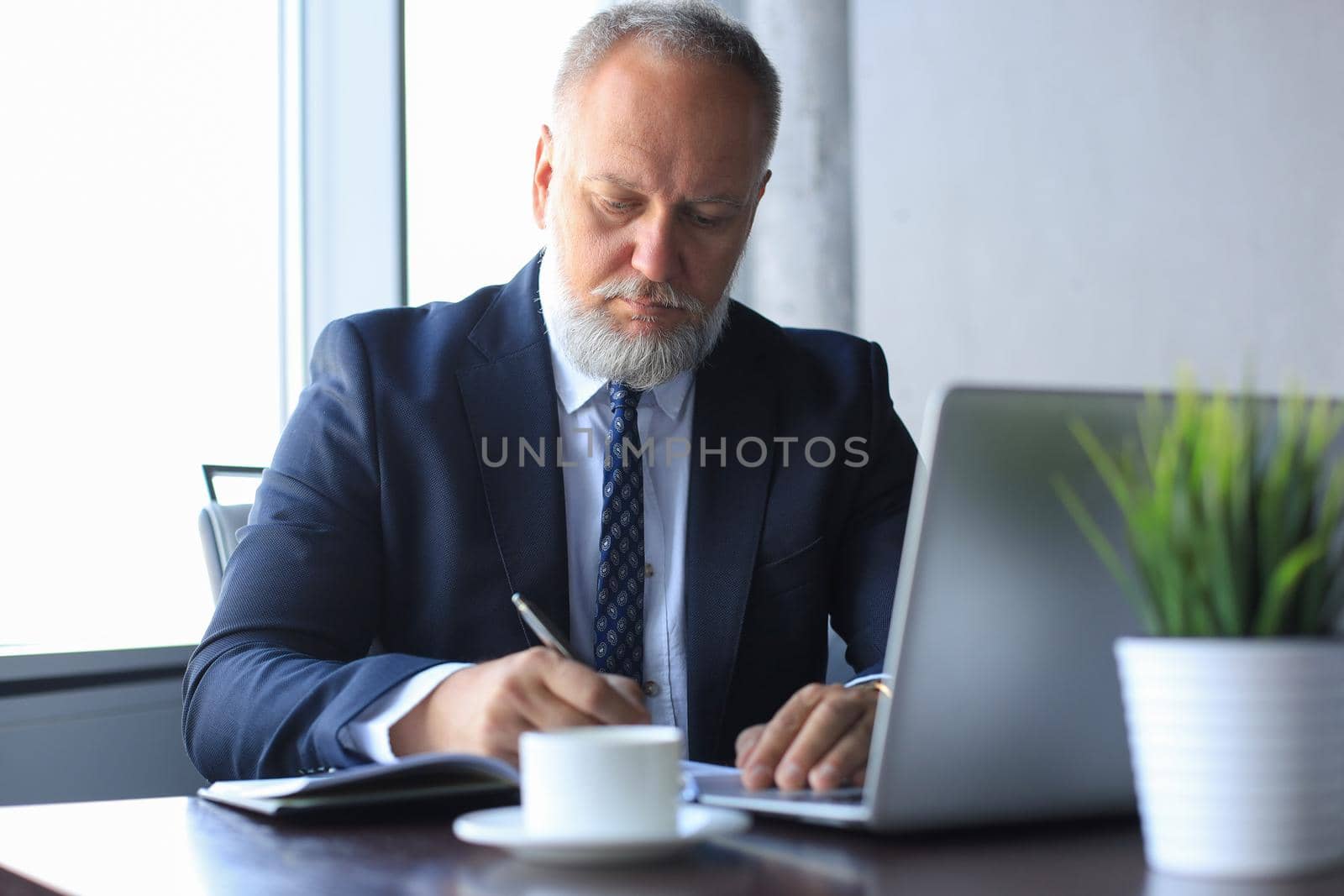 Modern businessman thinking about something while sitting in the office.