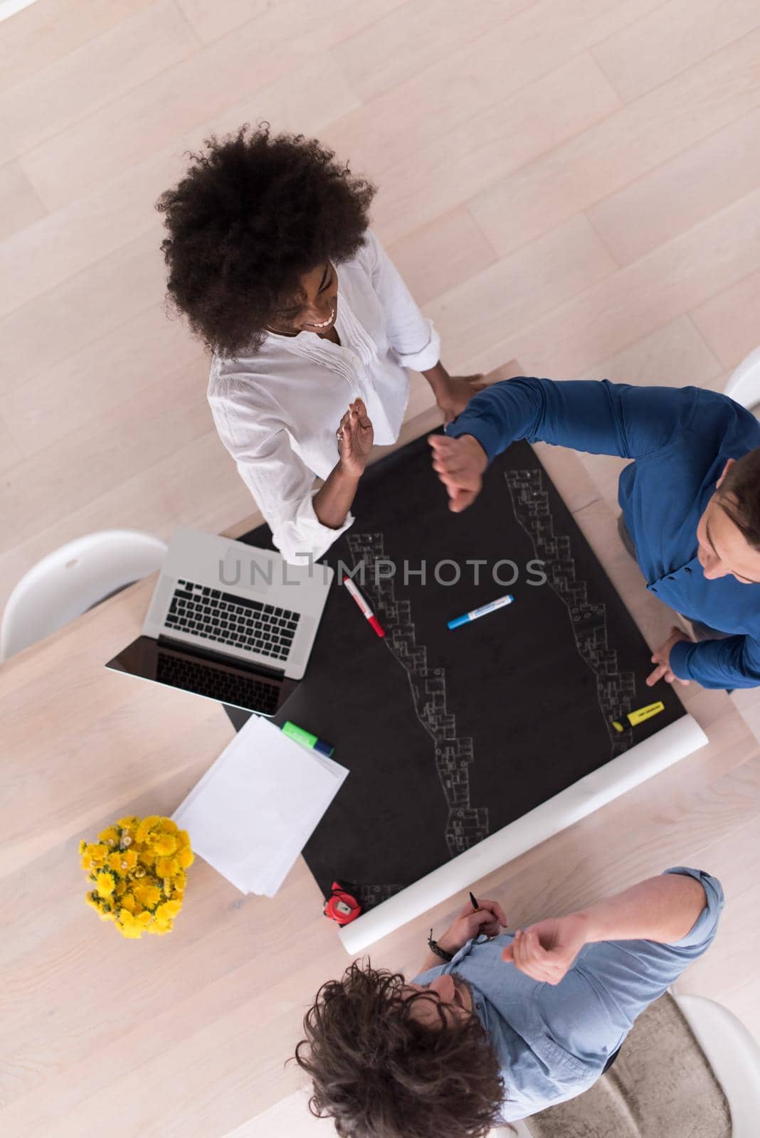 Multiethnic startup business team on meeting in modern bright office interior brainstorming, top view