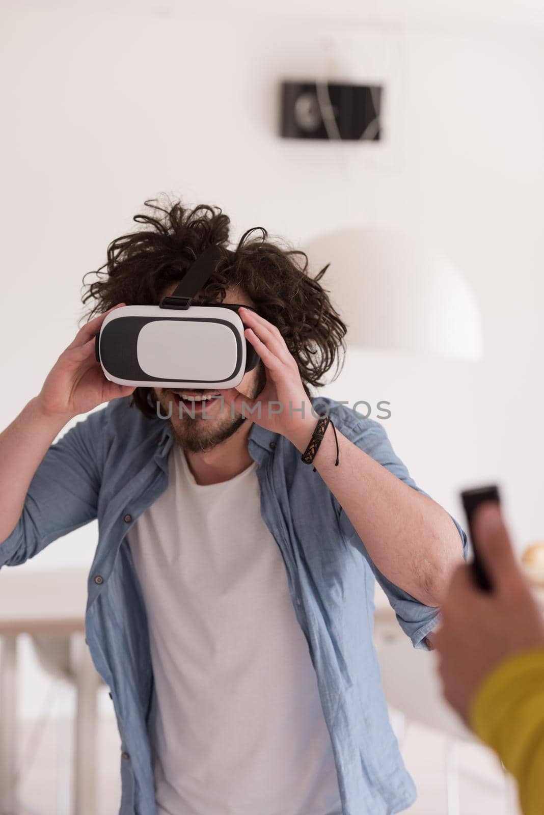 happy man getting experience using VR-headset glasses of virtual reality at home