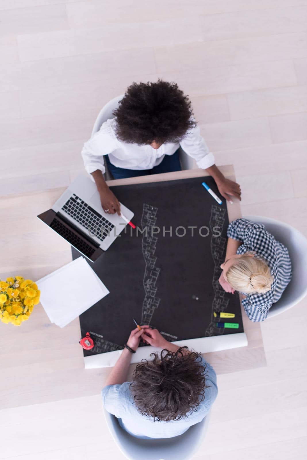 Multiethnic startup business team on meeting in modern bright office interior brainstorming, top view