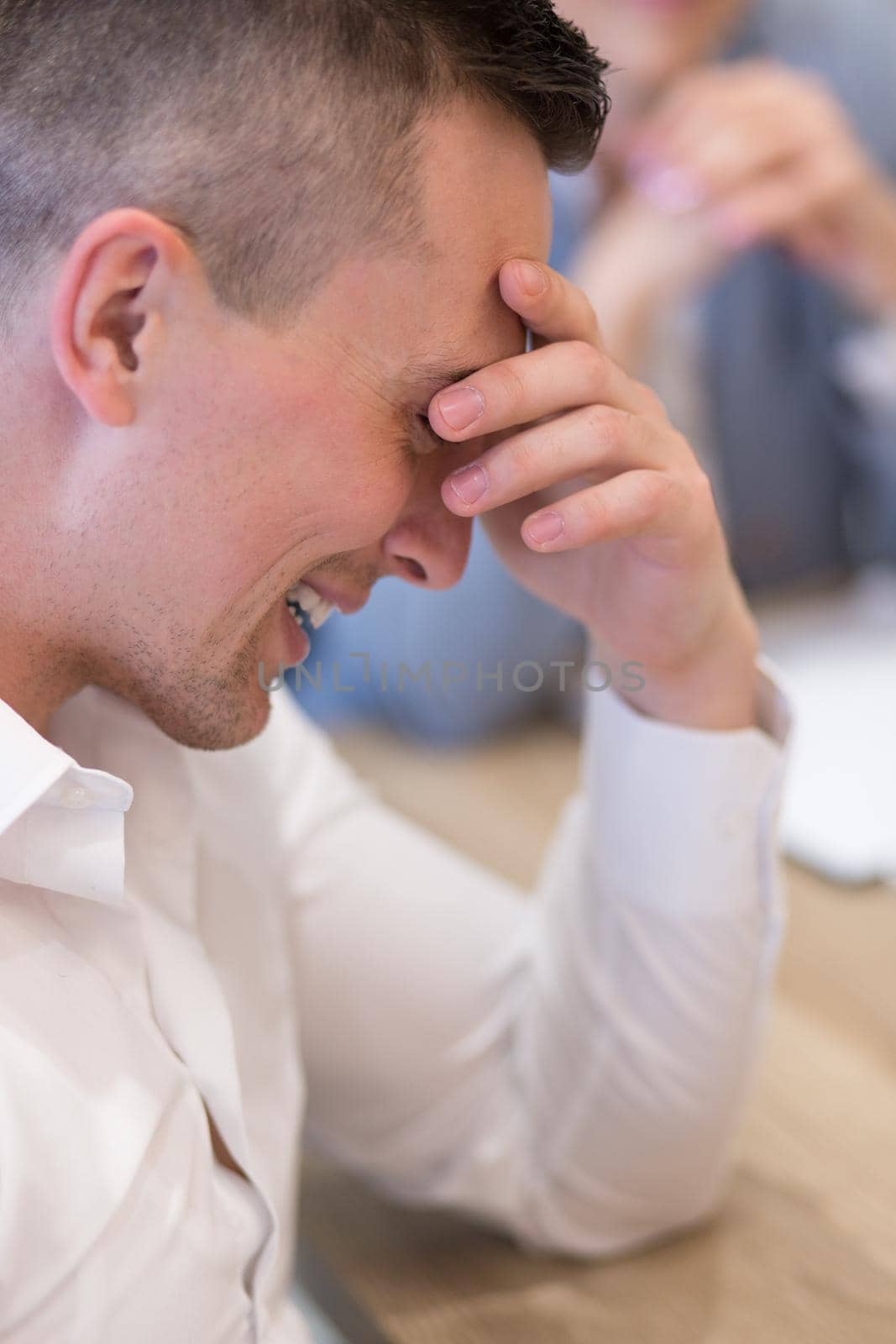 A time for relax. Young tired casual businessman relaxing at the desk in his office