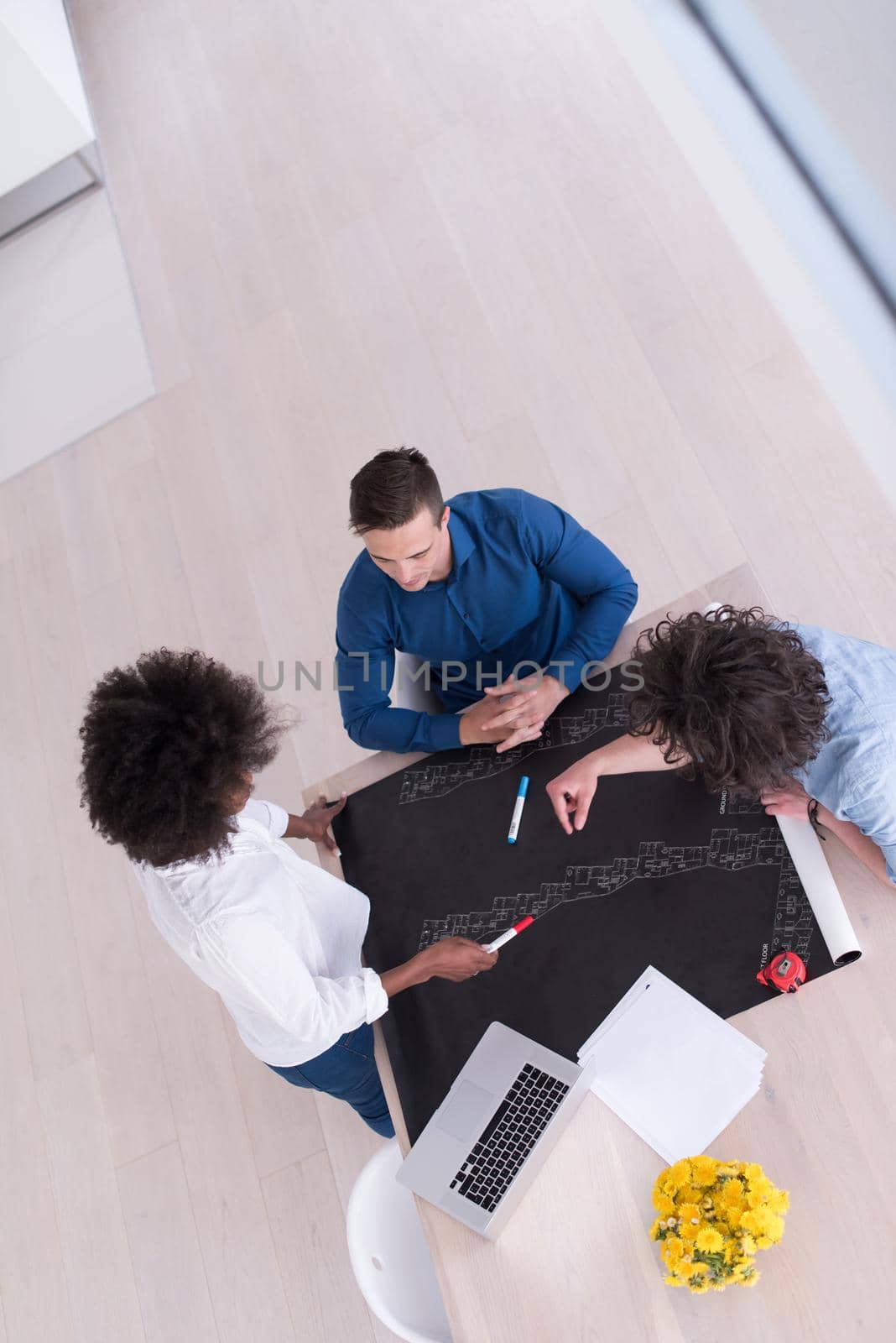 Multiethnic startup business team on meeting in modern bright office interior brainstorming, top view