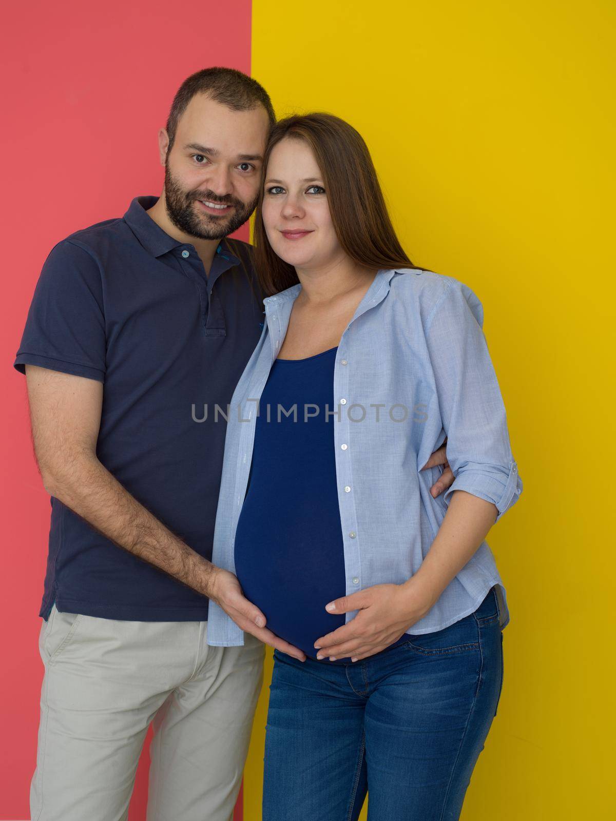 pregnant couple  isolated over colorful background by dotshock