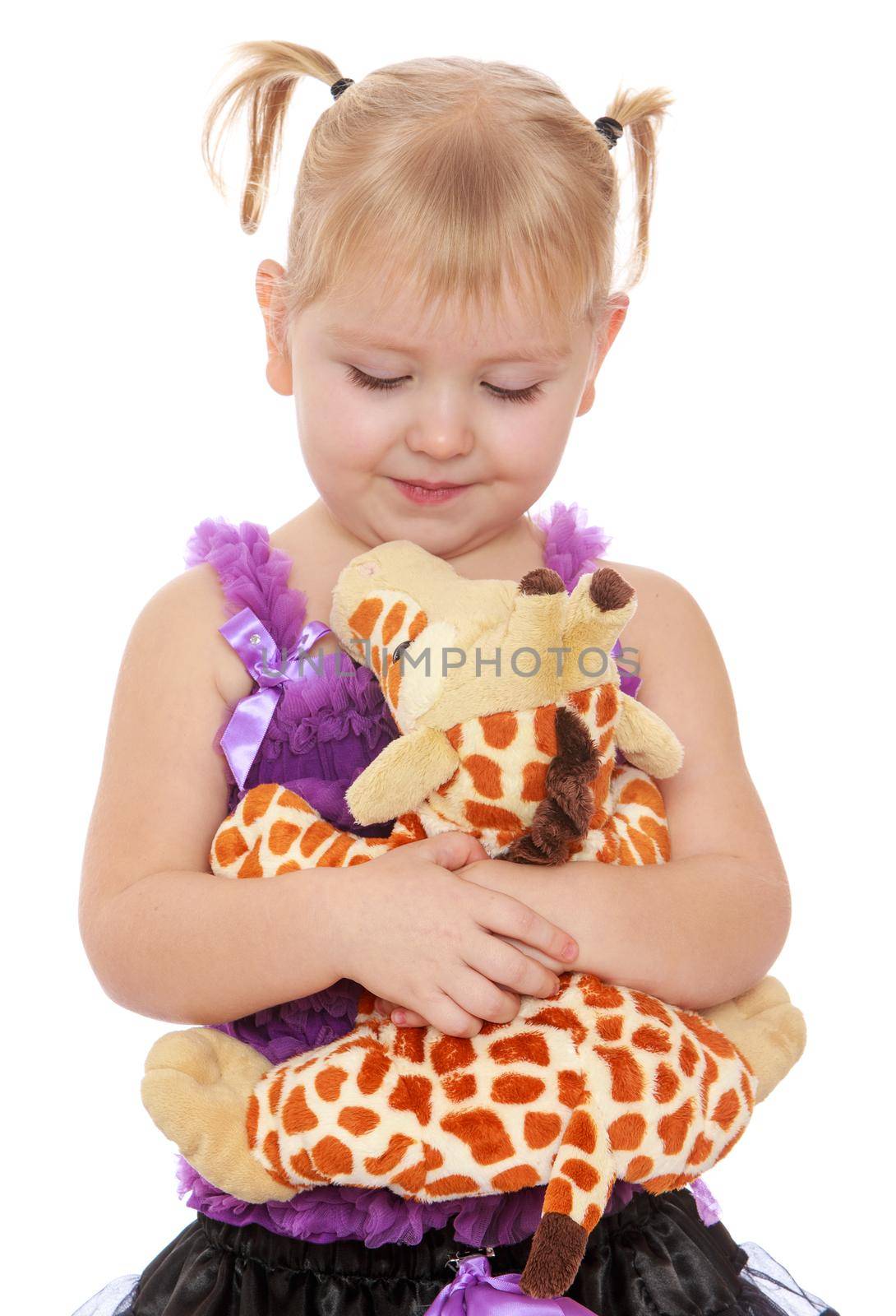 Nice little girl with thin pigtails on the head hugging a toy giraffe . close-up-Isolated on white background