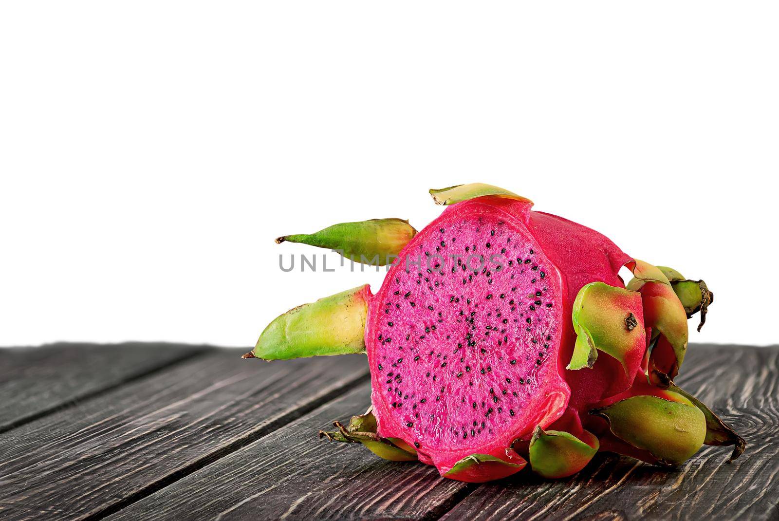 Half dragon fruit on planks isolated on white by Cipariss
