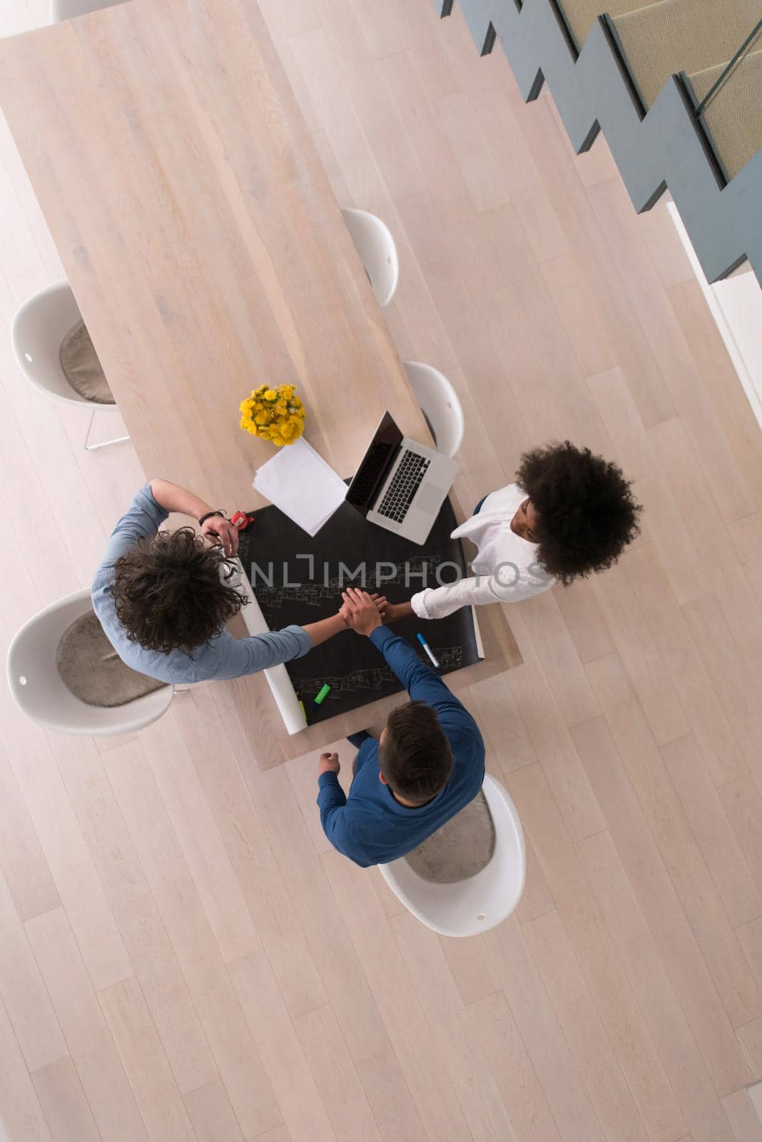 Multiethnic startup business team on meeting in modern bright office interior brainstorming, top view