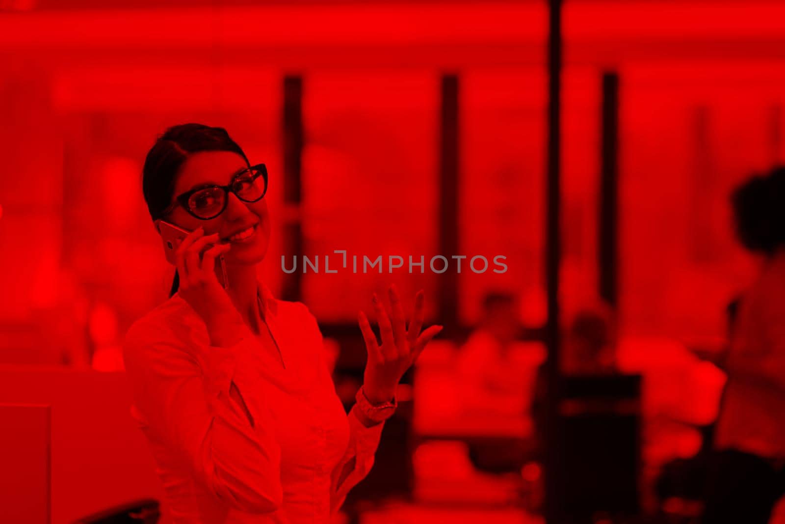 Elegant Woman Using Mobile Phone in startup office building by dotshock