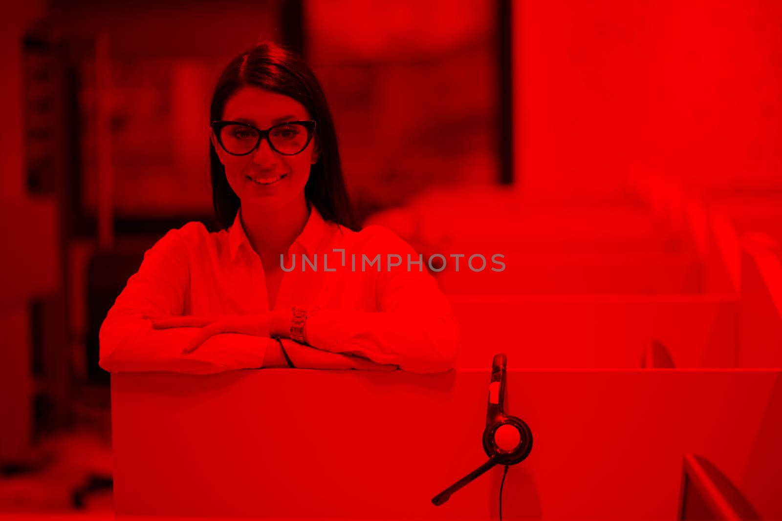 young smiling female call centre operator doing her job with a headset