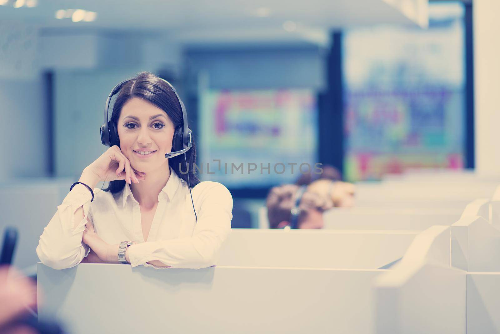 young smiling female call centre operator doing her job with a headset