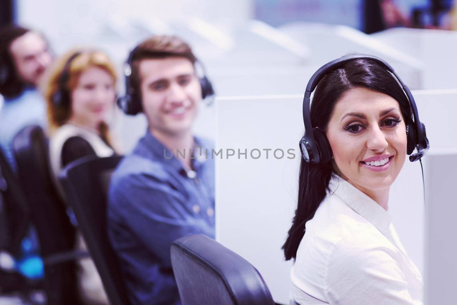 group of young business people with headset working and giving support to customers in a call center office