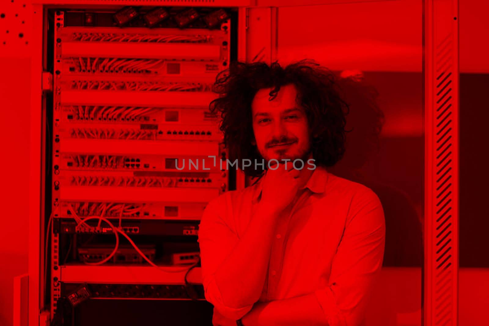 portrait of young handsome business man engeneer in datacenter server room