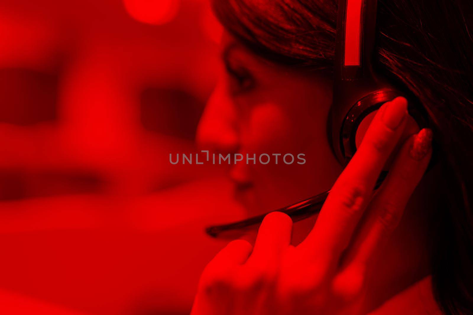 young smiling female call centre operator doing her job with a headset