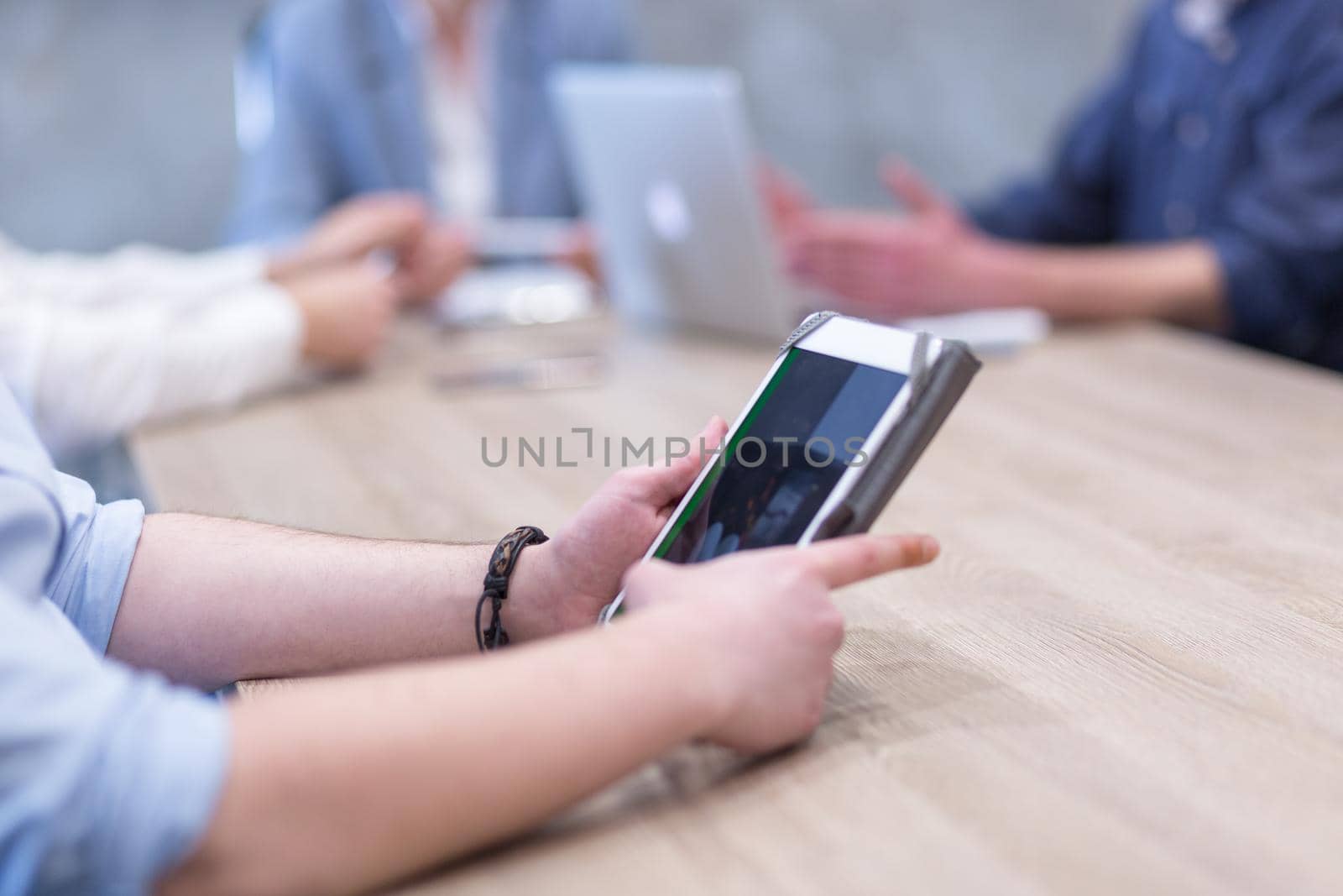 young casual businessman using tablet computer in startup office