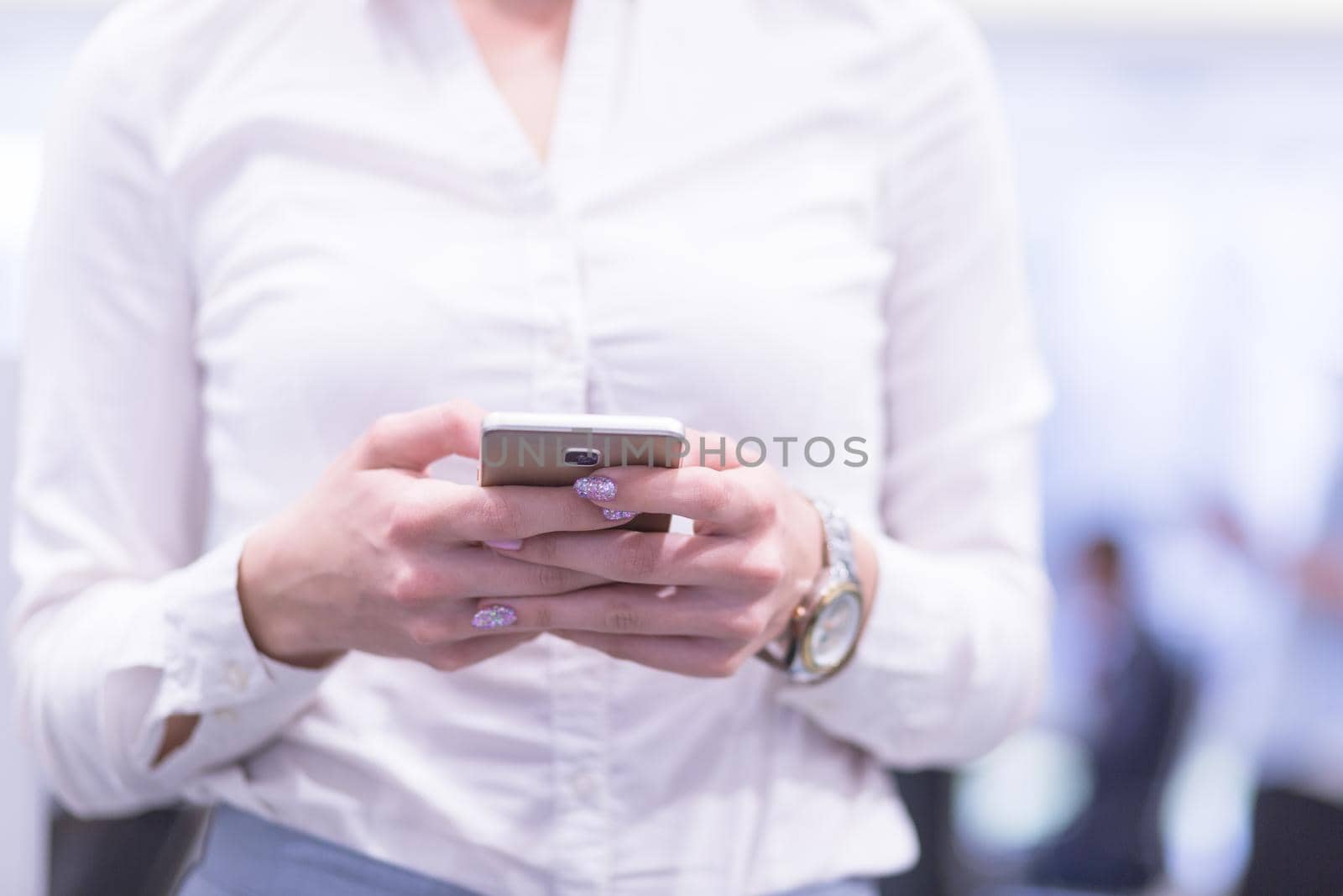 Elegant Woman Using Mobile Phone in startup office building by dotshock