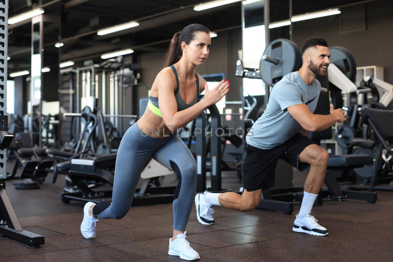 Attractive sport couple doing fitness at gym