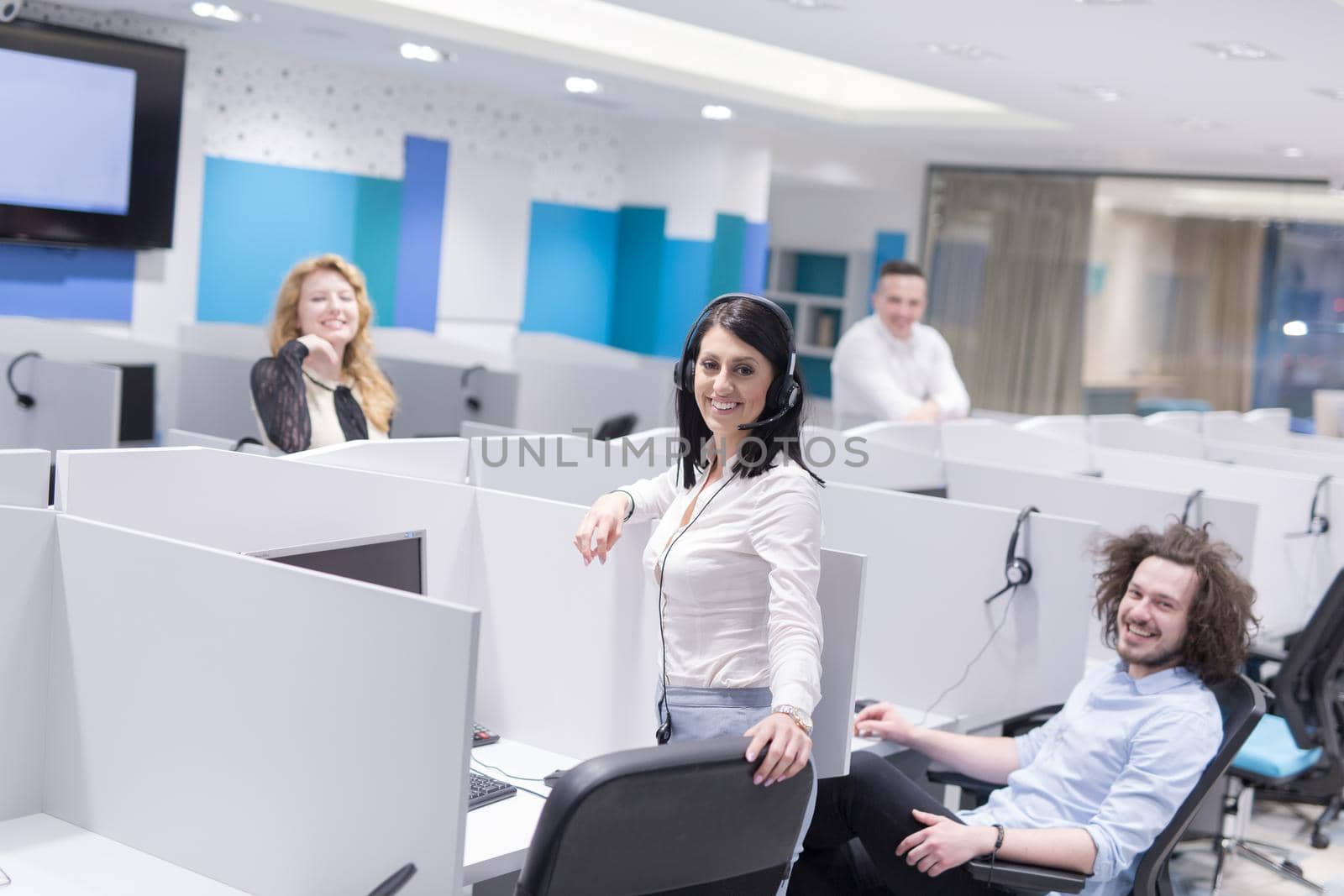 group of young business people with headset working and giving support to customers in a call center office