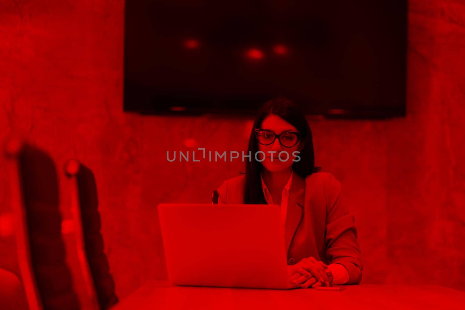 businesswoman using a laptop in startup office by dotshock