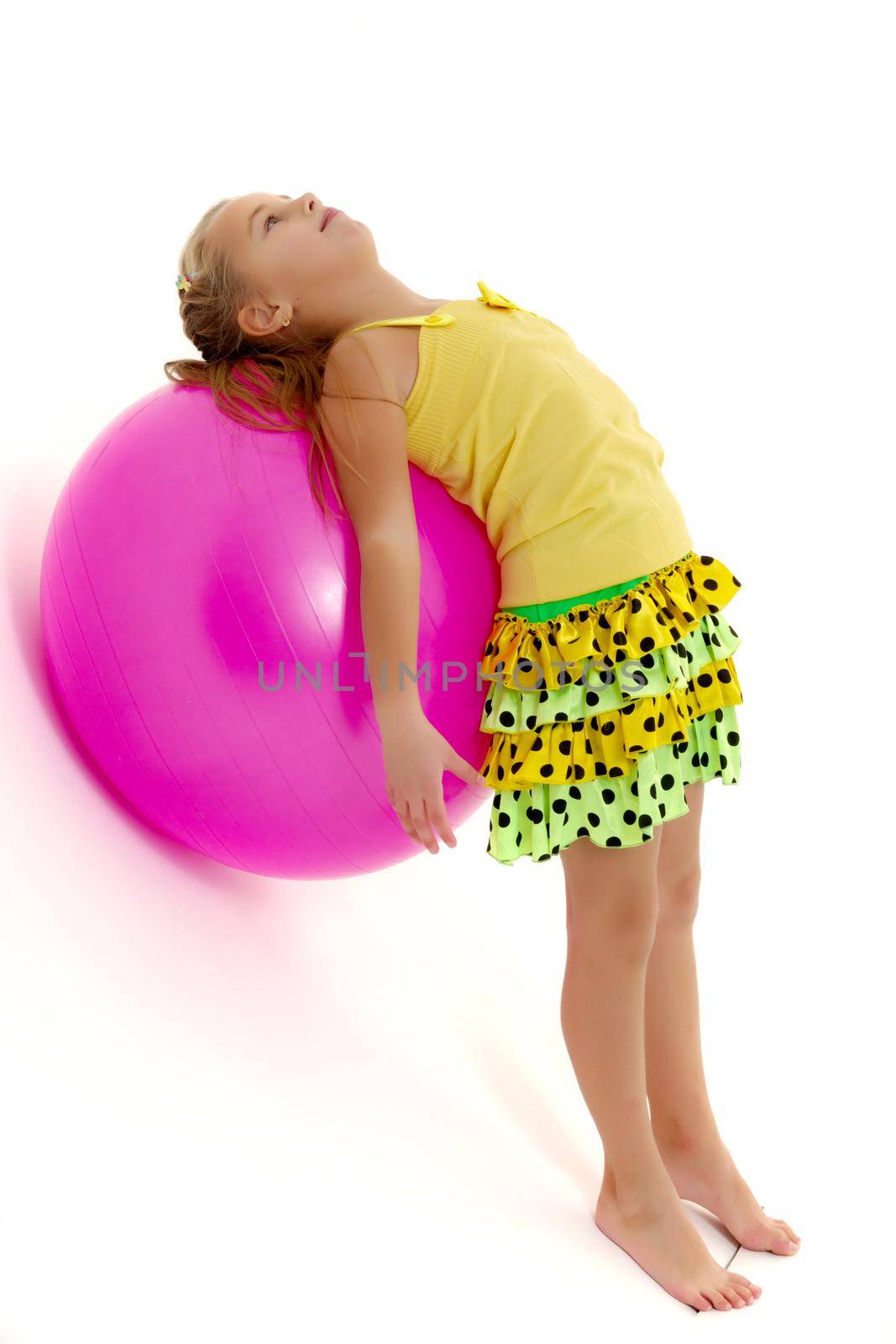 little girl doing exercises on a big ball for fitness. by kolesnikov_studio