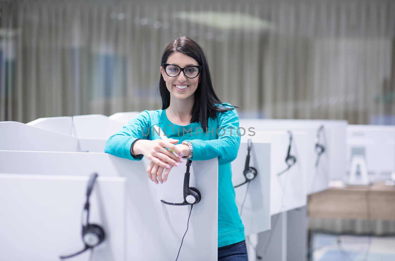 young smiling female call centre operator doing her job with a headset