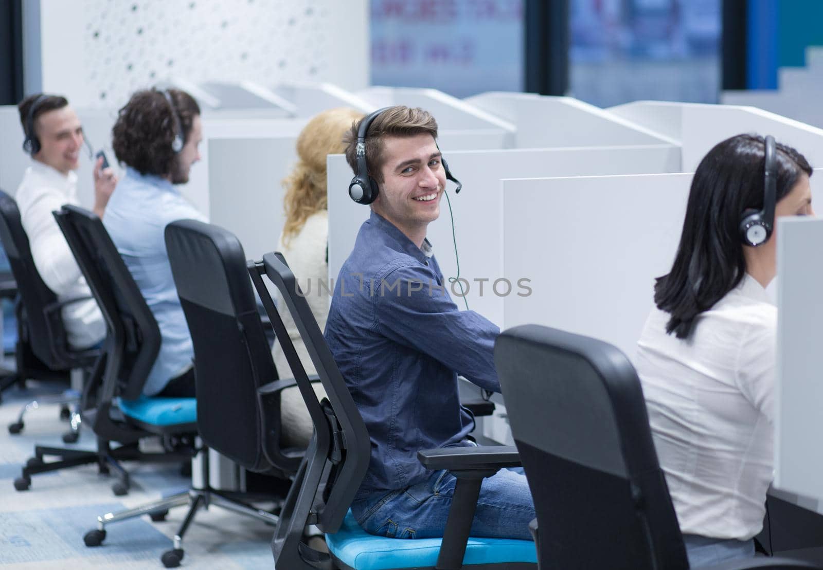 group of young business people with headset working and giving support to customers in a call center office