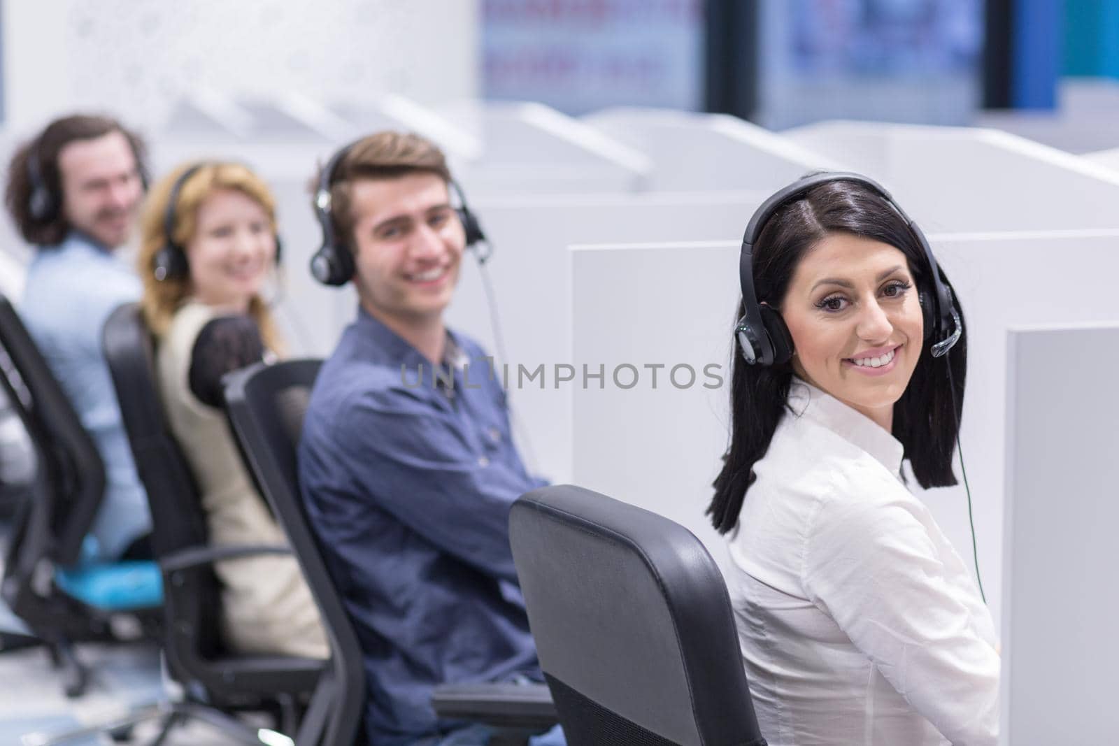 group of young business people with headset working and giving support to customers in a call center office