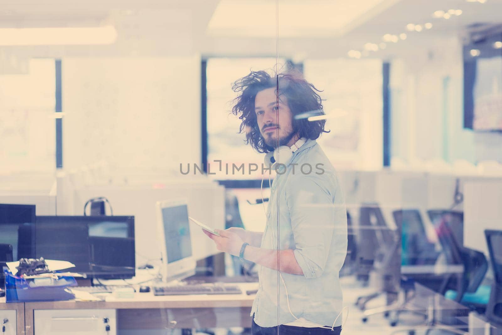 young casual businessman using tablet computer in startup office