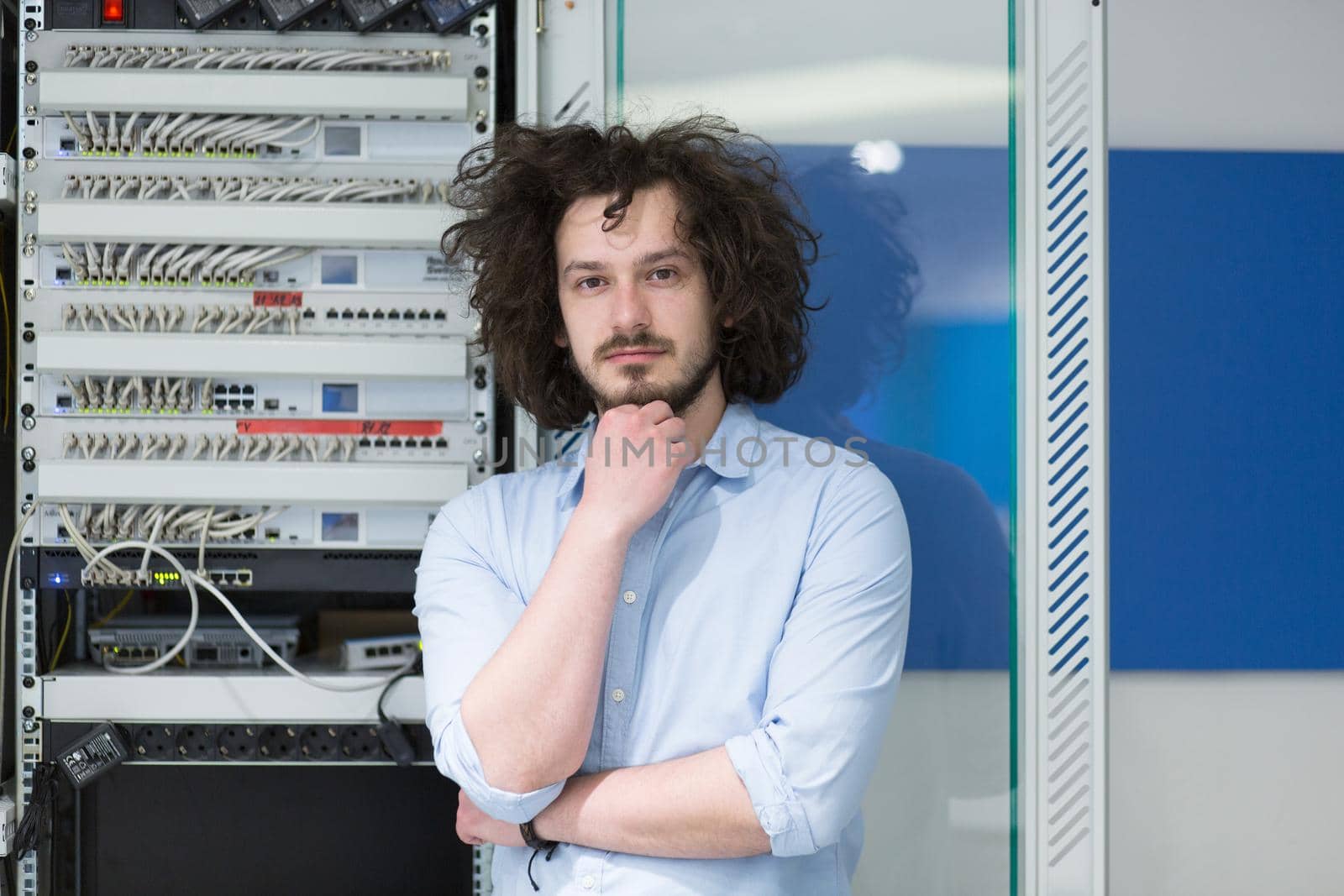 portrait of young handsome business man engeneer in datacenter server room