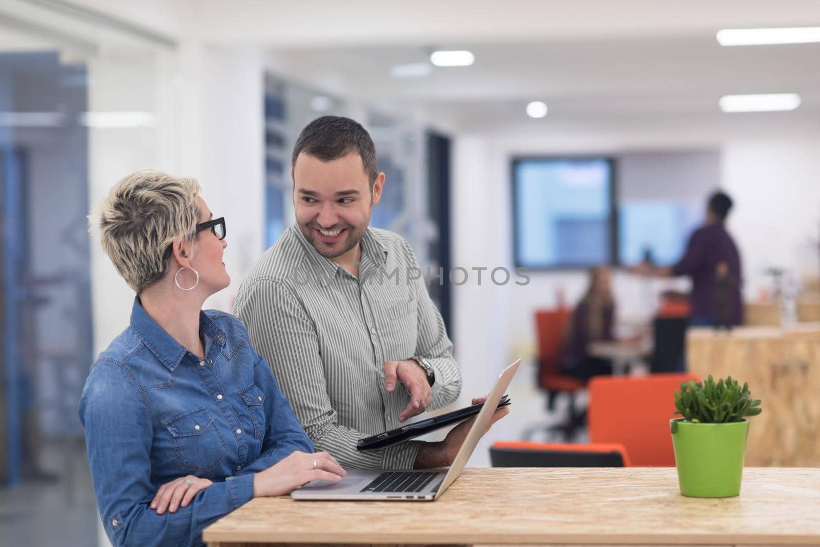 startup business team on meeting in modern bright office interior brainstorming, working on laptop and tablet computer