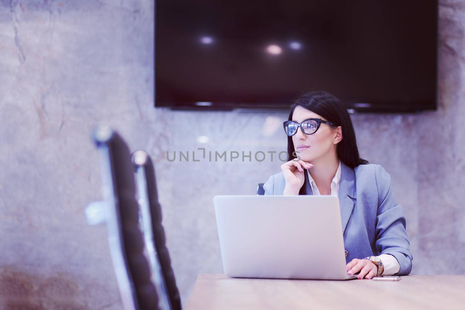 businesswoman using a laptop in startup office by dotshock