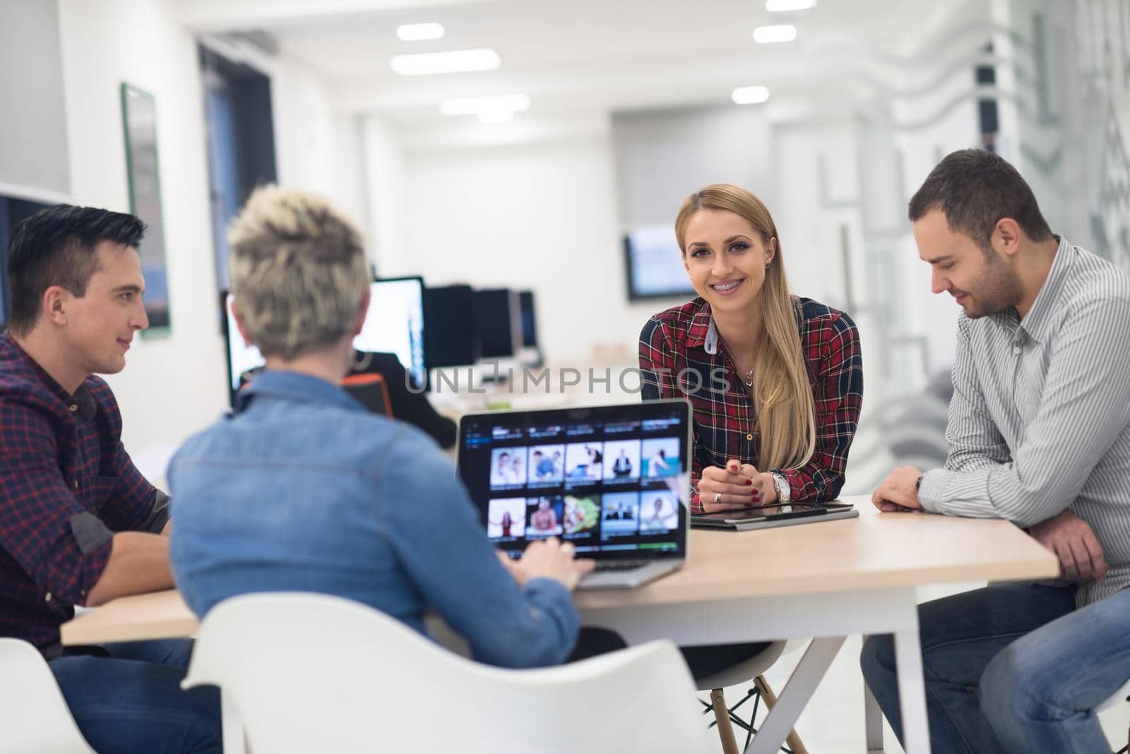 startup business team on meeting in modern bright office interior brainstorming, working on laptop and tablet computer