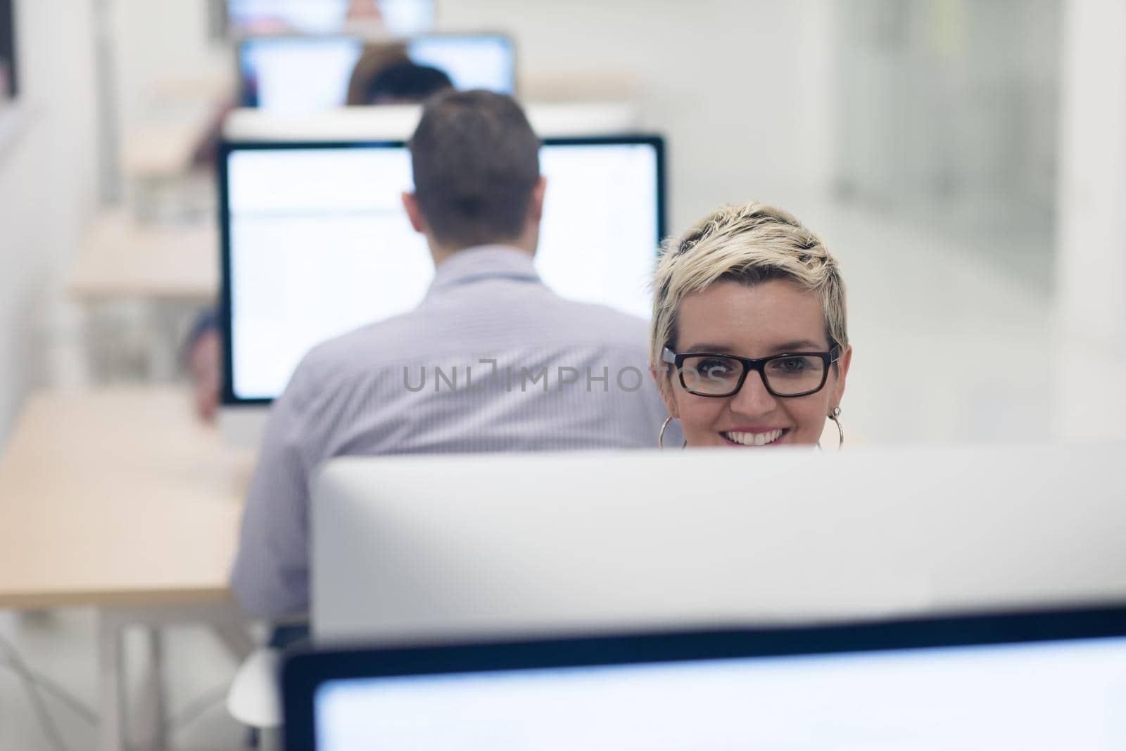 startup business, woman  working on dektop  computer at creative modern office relaxing and have fun