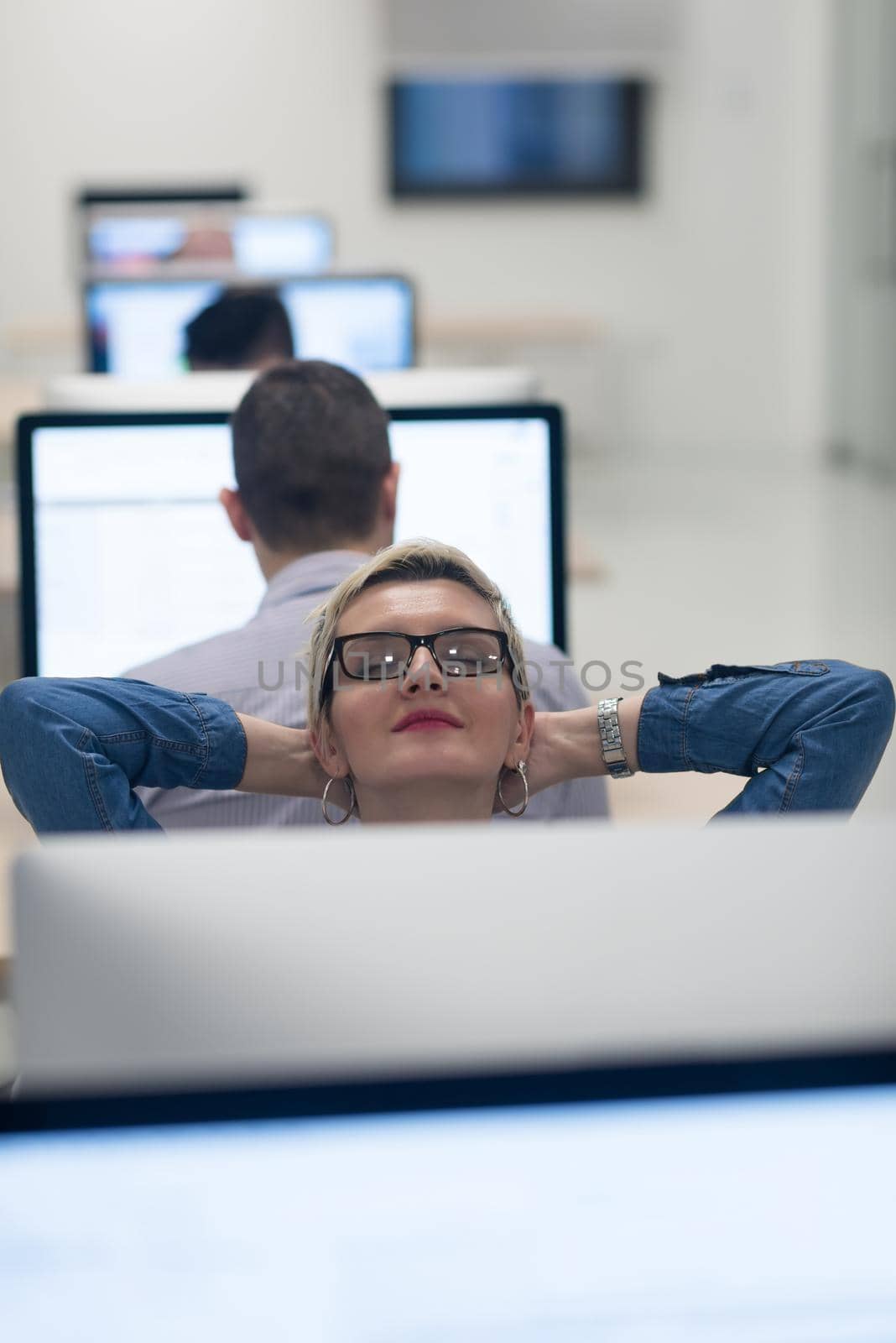 startup business, woman  working on dektop  computer at creative modern office relaxing and have fun