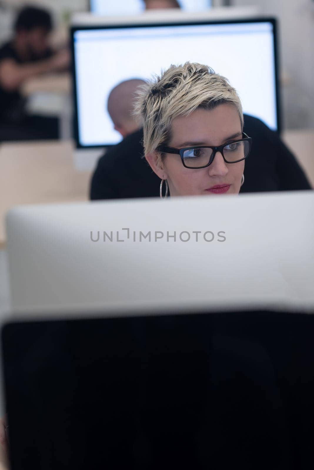 startup business, woman  working on dektop  computer at creative modern office relaxing and have fun