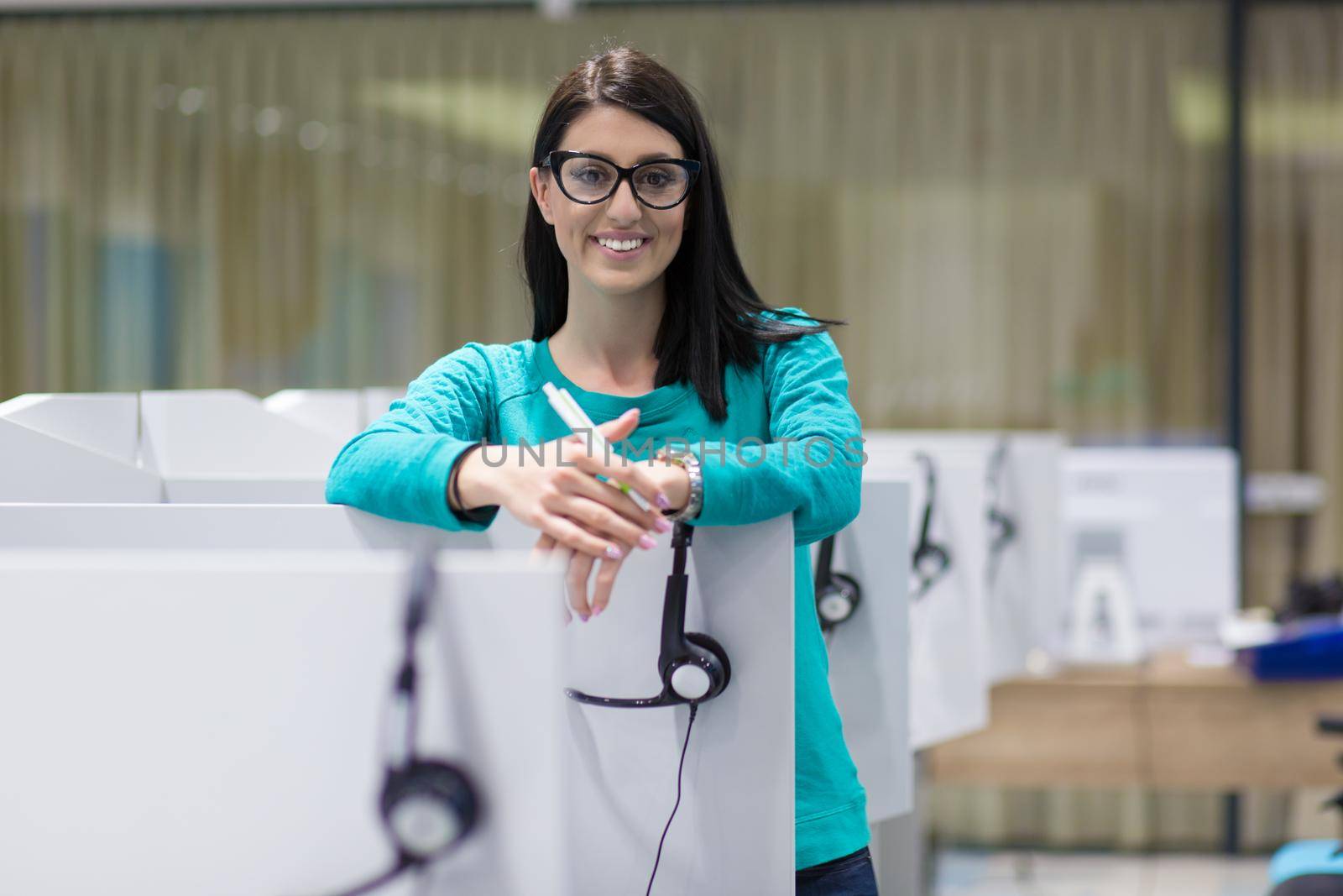 young smiling female call centre operator doing her job with a headset