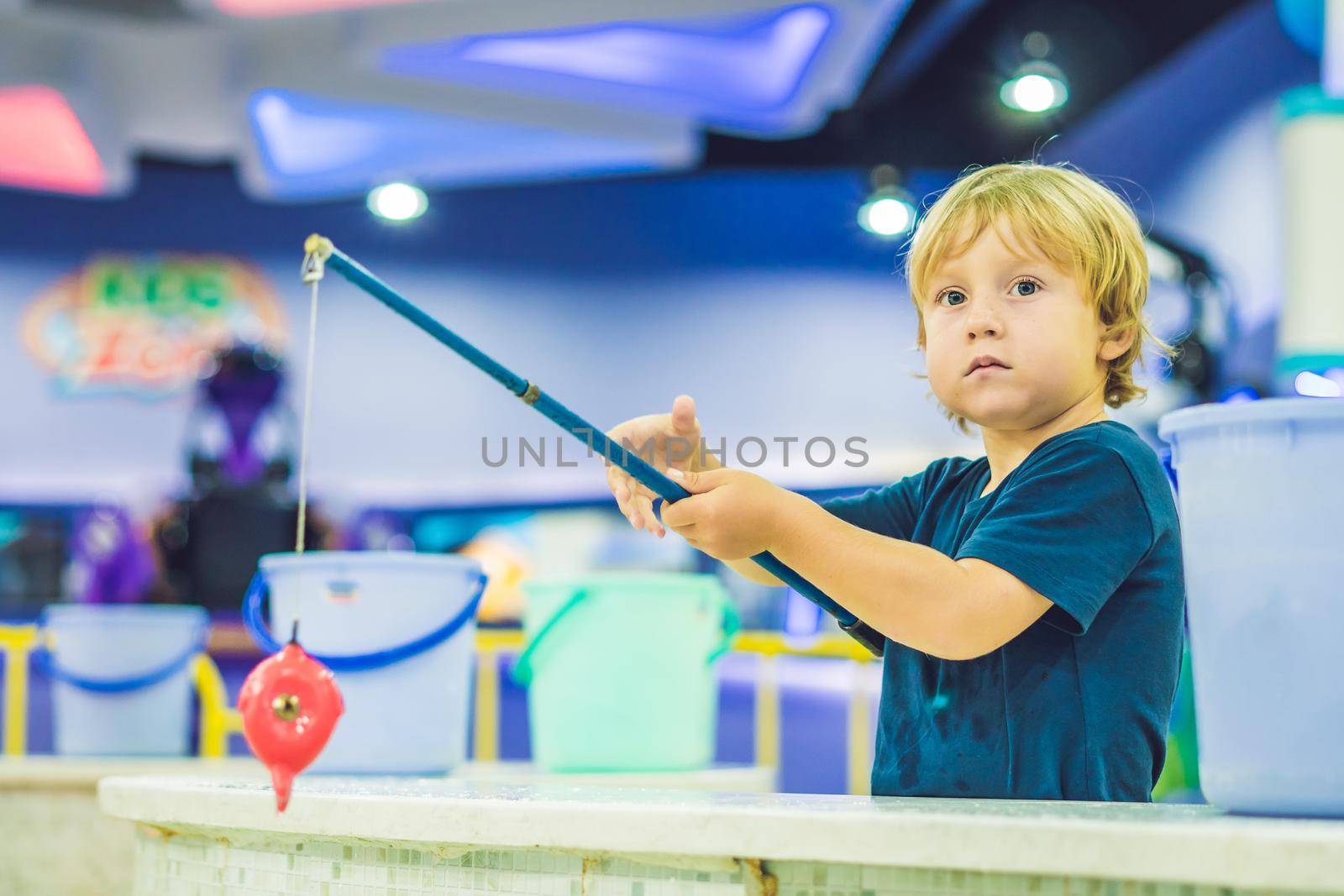 Cute boy in the playroom fishing. The development of fine motor concept. Creativity Game concept by galitskaya
