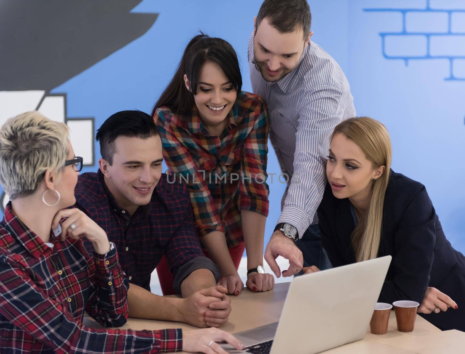 startup business team on meeting in modern bright office interior brainstorming, working on laptop and tablet computer