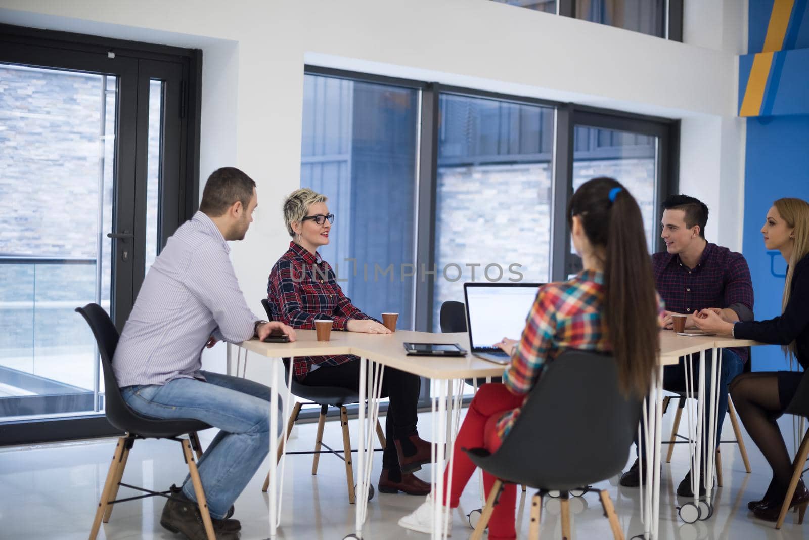 startup business team on meeting in modern bright office interior brainstorming, working on laptop and tablet computer