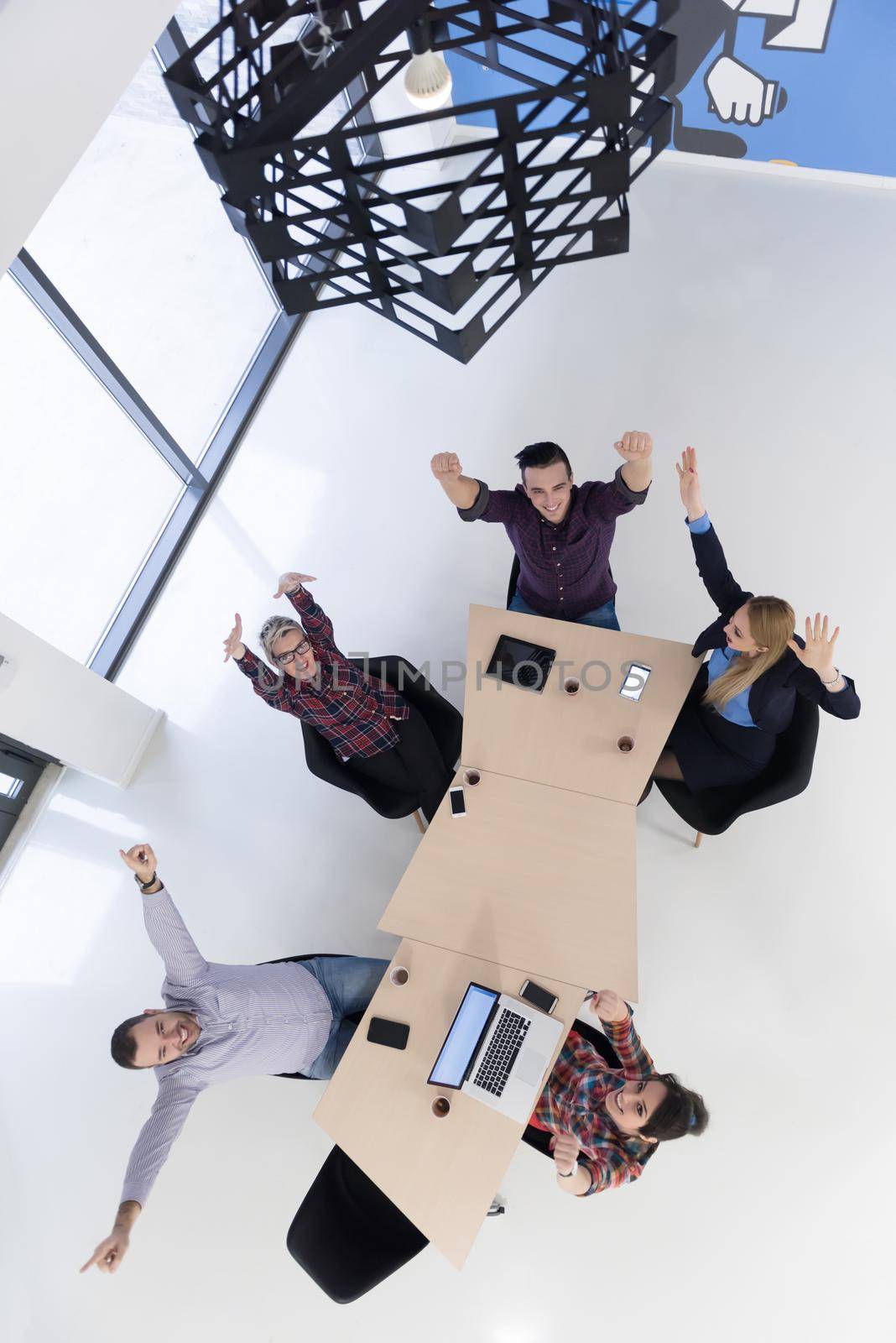 top view of multi ethnic startup business people group on brainstorming meeting in modern bright office interior