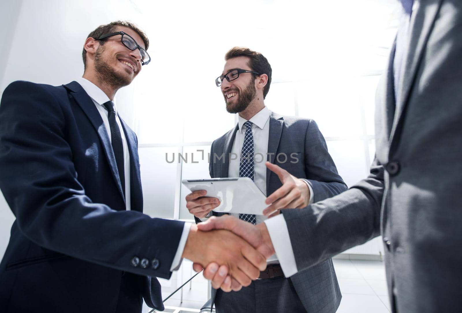 handshake business partners in a modern office . concept of partnership