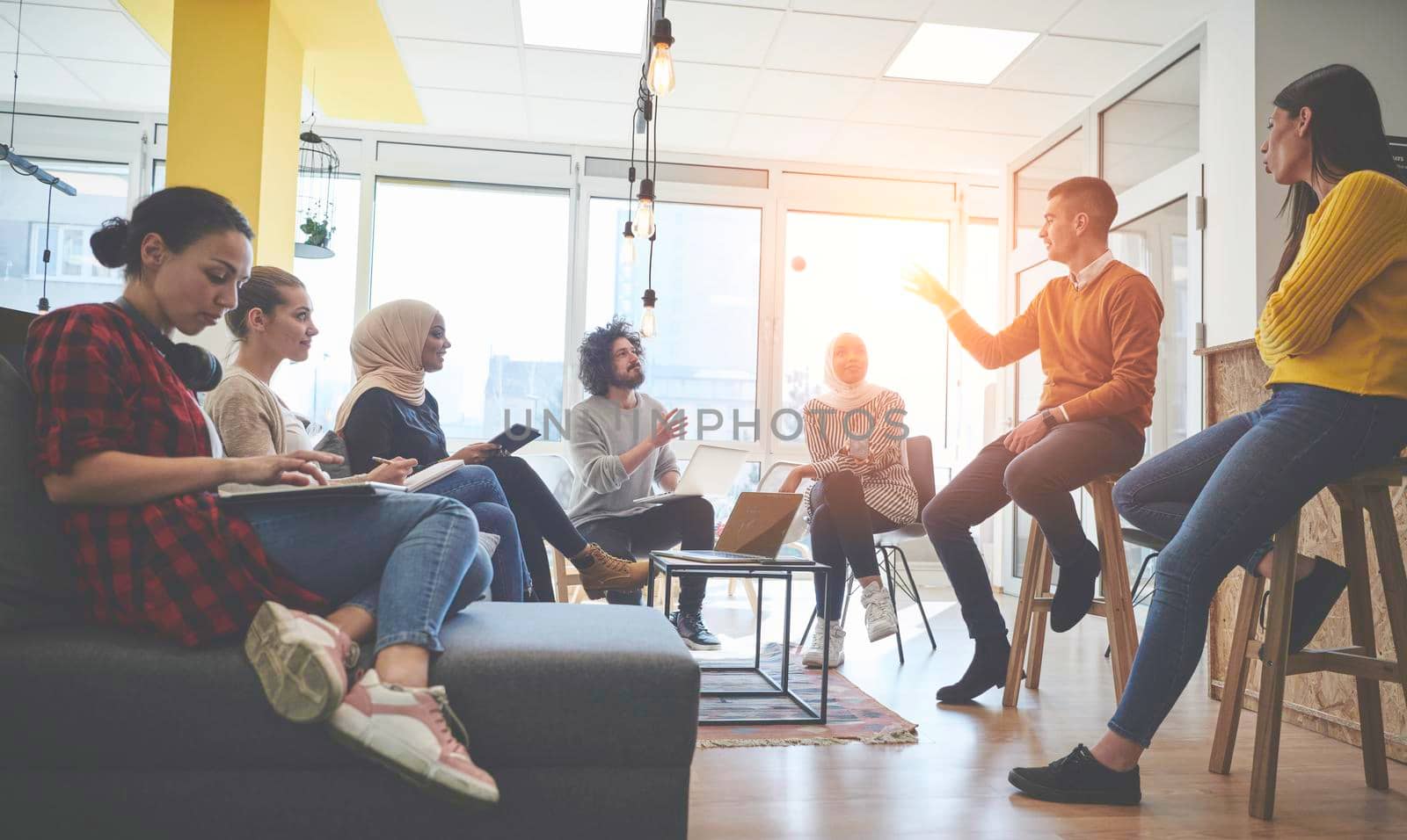 business people group in modern office have a team meeting and brainstorming while working on tablet or laptop  presenting ideas and take notes