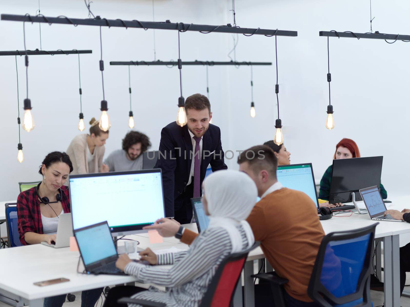 creative business people group as freelancers in modern coworking open space office by dotshock