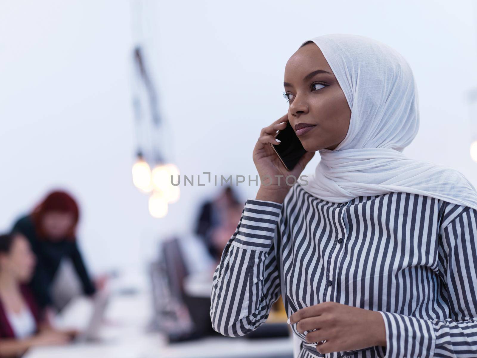 African muslim businesswoman  at office using smart phone by dotshock