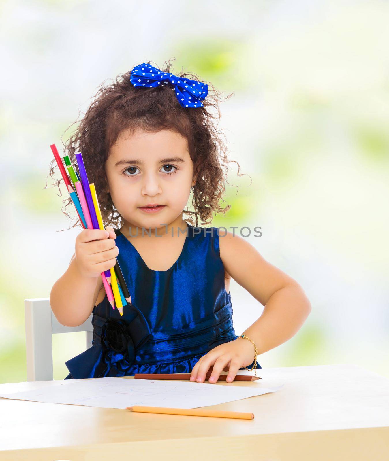 Little girl draws at the table with pencils by kolesnikov_studio