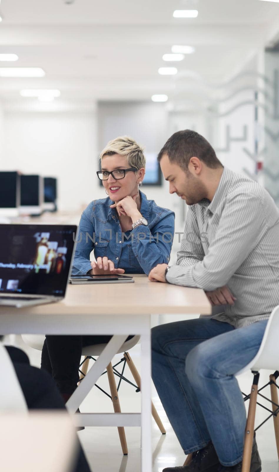 startup business team on meeting in modern bright office interior brainstorming, working on laptop and tablet computer