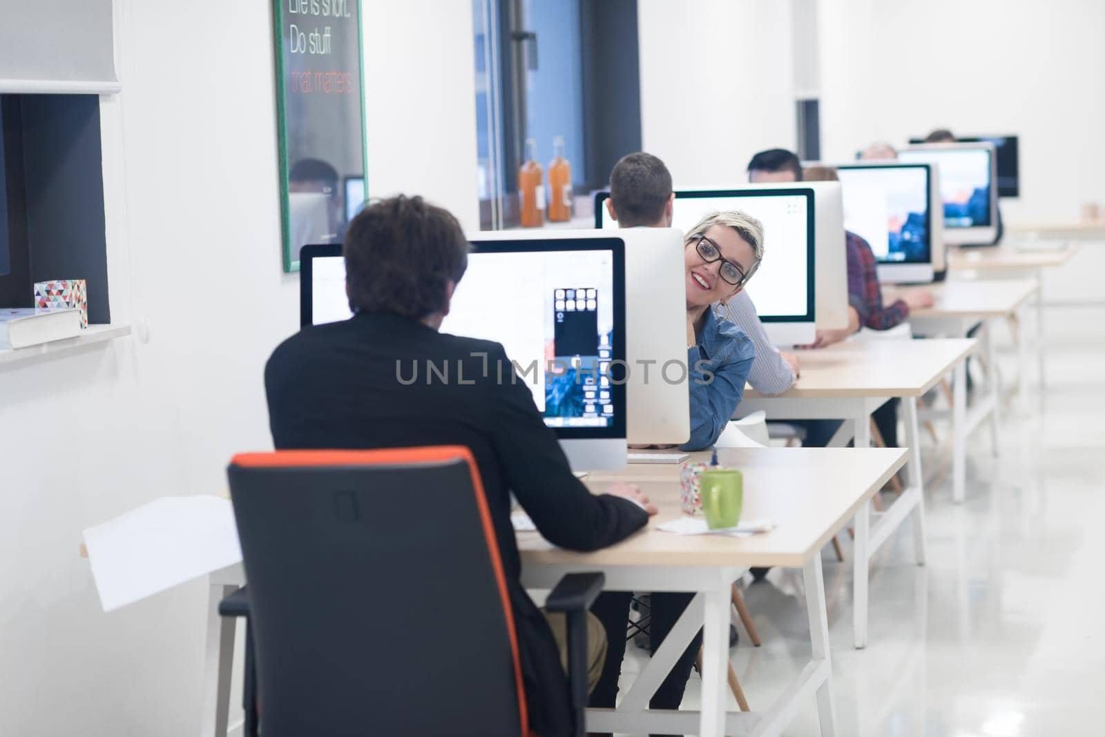 startup business, woman  working on dektop  computer at creative modern office relaxing and have fun