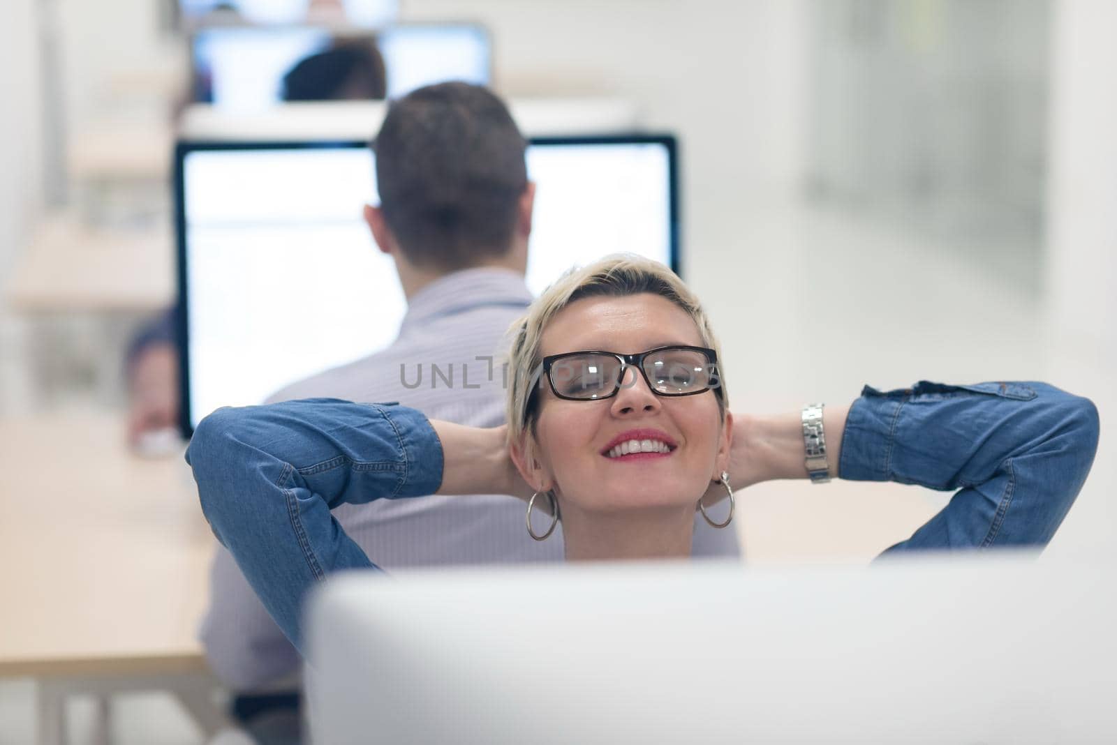 startup business, woman  working on dektop  computer at creative modern office relaxing and have fun