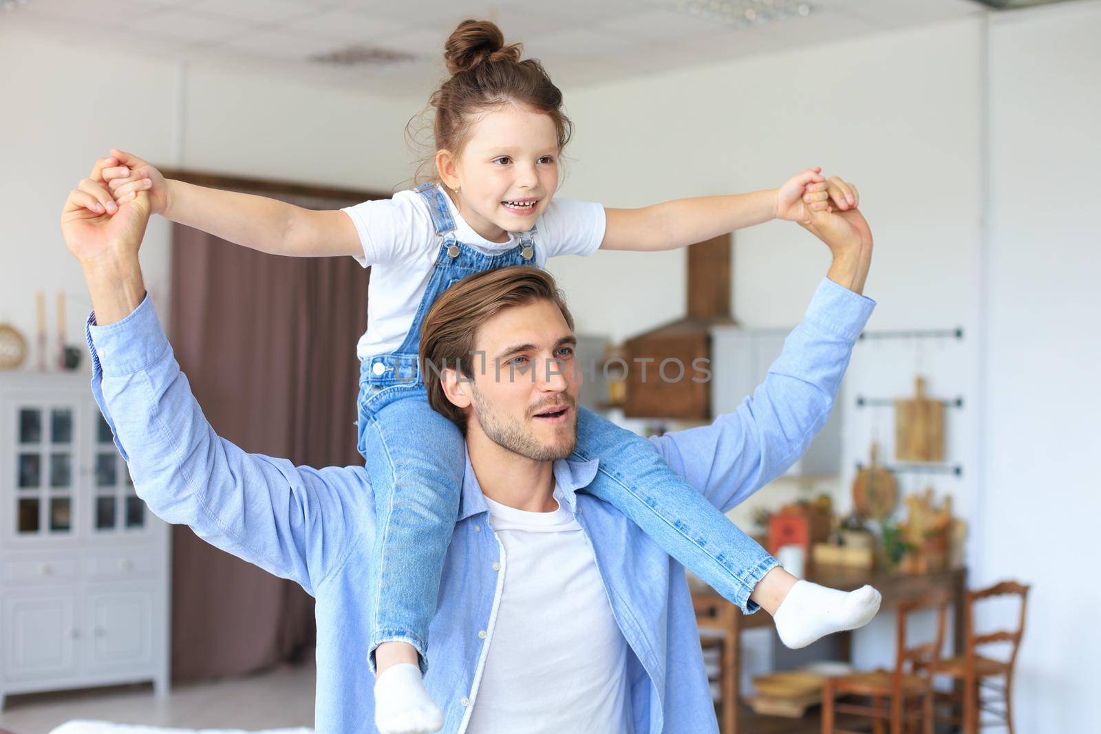 Father and his daughter child girl playing together. Father's day concept.