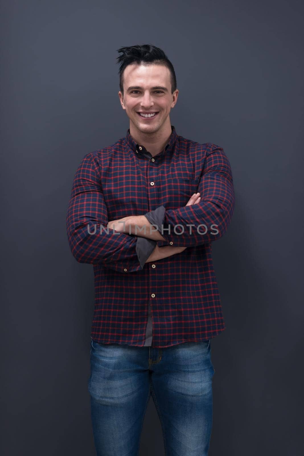 portrait of young business man in casual clothes grey wall in background