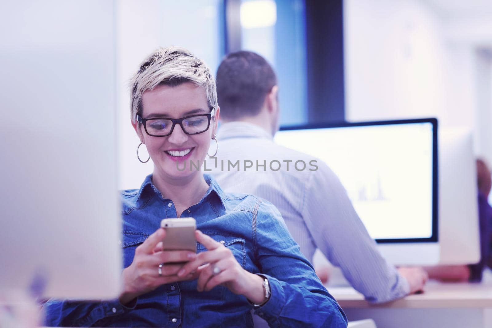 startup business, woman  working on dektop  computer at creative modern office relaxing and have fun