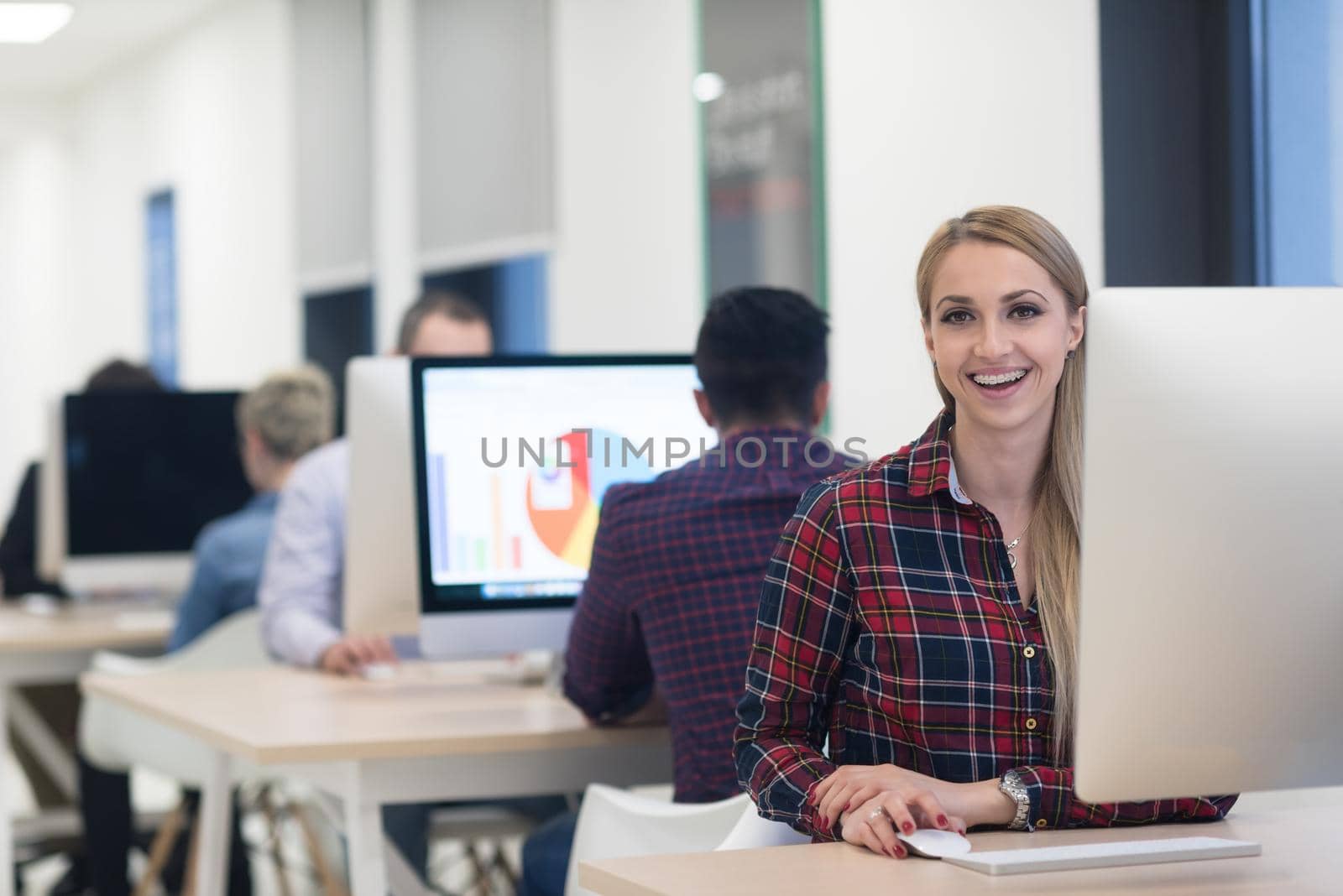 startup business, woman  working on dektop  computer at creative modern office relaxing and have fun